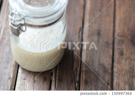 Freshly mixed homemade shio koji made from dried koji that has just begun to foam. Freshly mixed homemade shio koji made from dried koji that has just begun to foam. 130997368