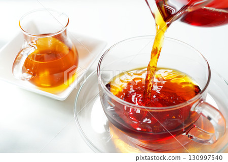 Honey tea poured into a teacup Honey tea poured into a teacup 130997540