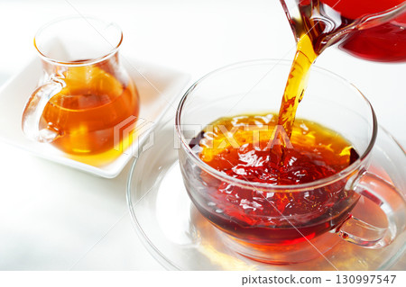 Honey tea poured into a teacup Honey tea poured into a teacup 130997547