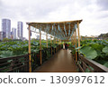 Wind chimes ringing from above the heads of people strolling along the path 130997612
