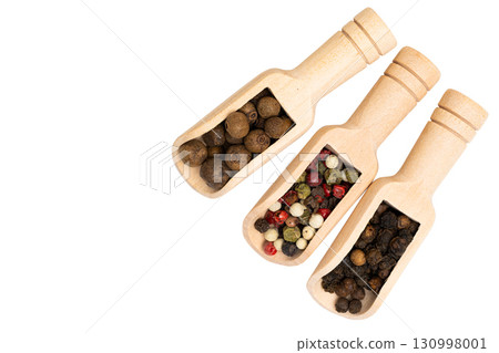 Spices in a wooden spoon isolated 130998001