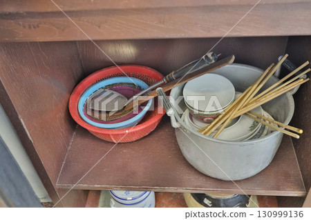 Sept 13 2025 Traditional Kitchen Utensils and Dishware Displayed on Wooden Shelves Indoors 130999136