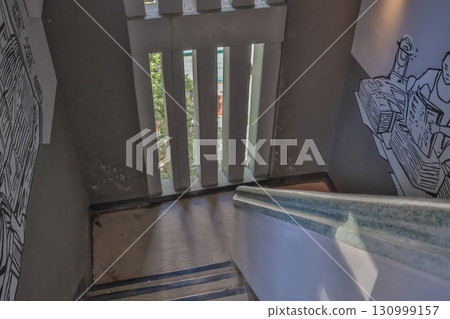 Sept 13 2025 Dimly Lit Stairwell with Artistic Wall Murals and Natural Light Sept 13 2025 Dimly Lit Stairwell with Artistic Wall Murals and Natural Light 130999157