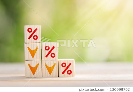 Interest rate financial and mortgage rates concept. Wooden cube block with interest rate and down arrow. Interest rate financial and mortgage rates concept. Wooden cube block with interest rate and down arrow. 130999702