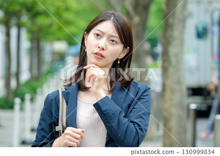 A troubled businesswoman in the city 130999834