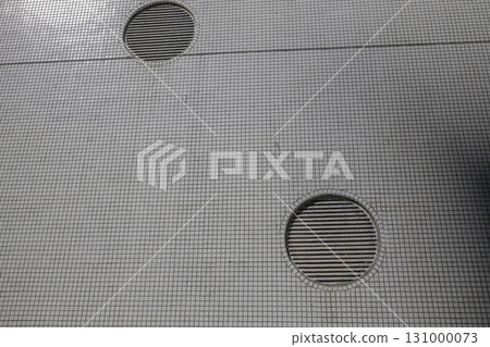 Sept 13 2025 Geometric Wall with Circular Vent Openings and Tiled Design in Subdued Lighting 131000073