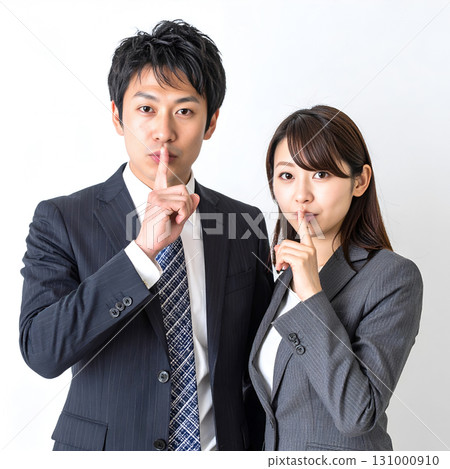 A business person posing with his index finger on his lips A business person posing with his index finger on his lips 131000910