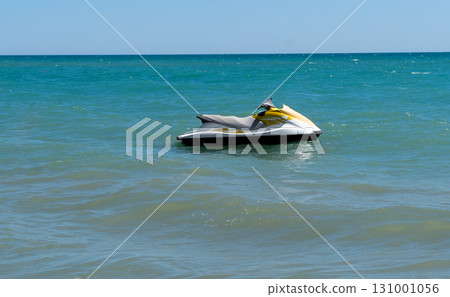 Blue sea and a jet ski floating on the sea. Water scooter is in the blue sea. 131001056