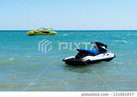 Blue sea with a jet ski and speedboat floating on the sea. Water scooter and speed boat is in the blue sea. 131001057