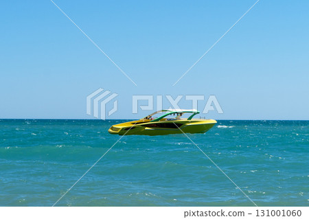 Blue sea and a speedboat floating on the sea. Speed boat is in the blue sea. Blue sea and a speedboat floating on the sea. Speed boat is in the blue sea. 131001060