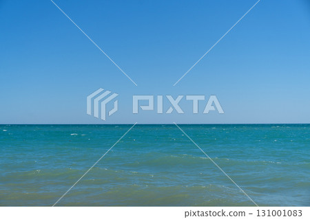 Blue sea waves. Wave splashing over pebbles at sea. Rolling ocean waves. Summer paradise beach background. Powerful sea waves Blue sea waves. Wave splashing over pebbles at sea. Rolling ocean waves. Summer paradise beach background. Powerful sea waves 131001083