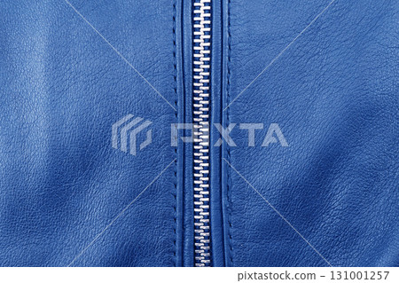 Macro shot of zipper on blue leather texture background with stitching. Close-up of black leather material Macro shot of zipper on blue leather texture background with stitching. Close-up of black leather material 131001257