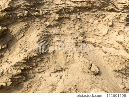 Heap building sand material. Heap of sand texture background. The rough texture of construction sand. Building material background Heap building sand material. Heap of sand texture background. The rough texture of construction sand. Building material background 131001306