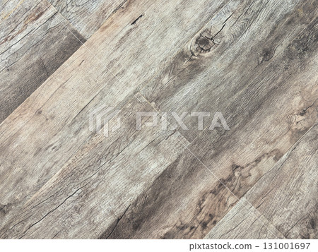 Laminated wood floor. Empty room with floating laminate in new apartment. Dark walnut chevron surface. Premium oiled oak parquet texture. 131001697