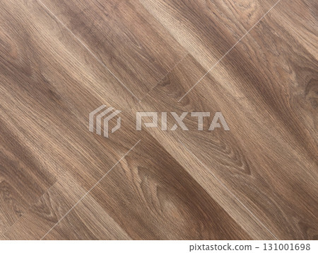 Laminated wood floor. Empty room with floating laminate in new apartment. Dark walnut chevron surface. Premium oiled oak parquet texture. Laminated wood floor. Empty room with floating laminate in new apartment. Dark walnut chevron surface. Premium oiled oak parquet texture. 131001698