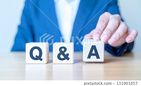 Businessman holding Q&A blocks 131001857