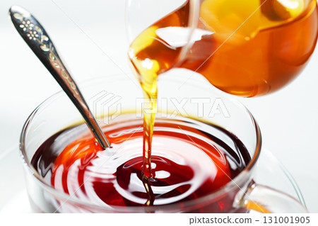 Pouring honey into tea: Honey tea Pouring honey into tea: Honey tea 131001905