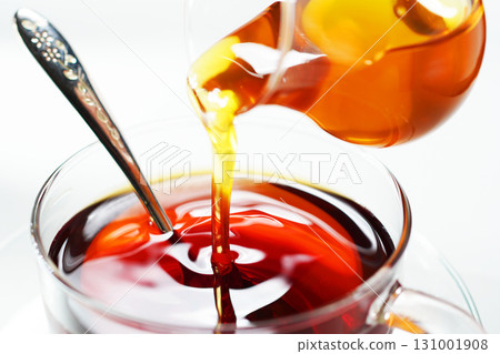 Pouring honey into tea: Honey tea 131001908