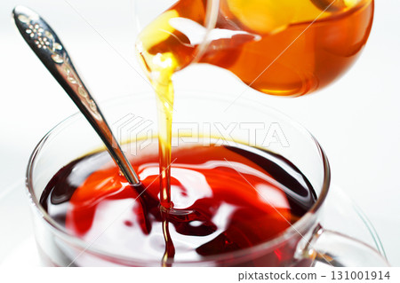 Pouring honey into tea: Honey tea Pouring honey into tea: Honey tea 131001914