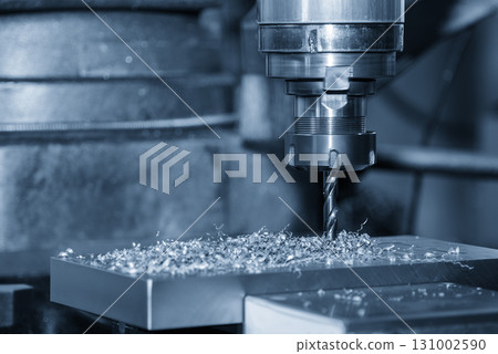 The hole drilling process on NC milling machine with aluminum parts in the blue scene. The hole drilling process on NC milling machine with aluminum parts in the blue scene. 131002590