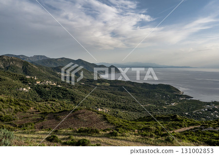 Village beach view Roadtrip Winding road along rocky coast of Cap Corse peninsula on Corsica island France 131002853