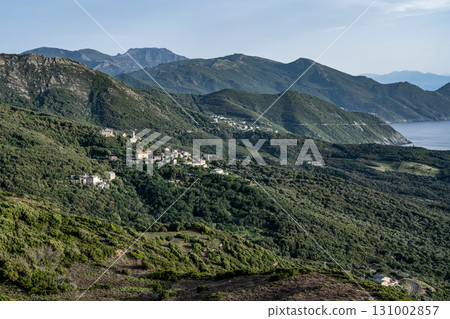 Village beach view Roadtrip Winding road along rocky coast of Cap Corse peninsula on Corsica island France Village beach view Roadtrip Winding road along rocky coast of Cap Corse peninsula on Corsica island France 131002857