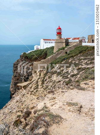 Cape Sao Vincente lighthouse rocky cliffs landscape ocean blue sky copy space 131003462