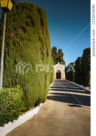 Chapel and green garden trees 131003696