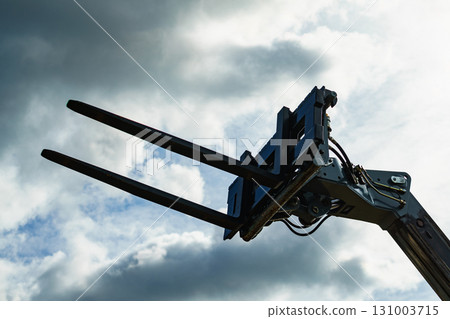 Forklift industrial loader or stacker against sky. 131003715