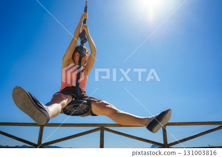 Adult woman having fun on zipline 131003816