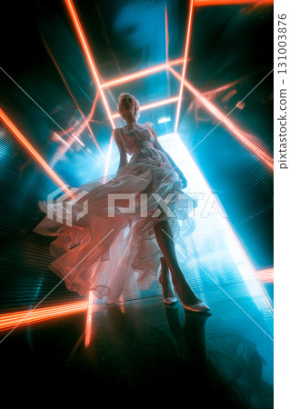 A woman in a long white dress is standing in a room with neon lights 131003876