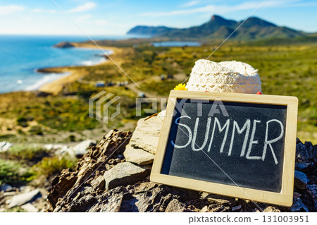 Black board with word summer against sea coast Black board with word summer against sea coast 131003951