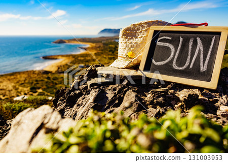 Black board with word sun against sea coast 131003953