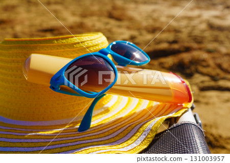 Sun protection gear on sand beach 131003957