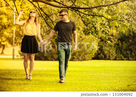 Couple taking walk through park. Couple taking walk through park. 131004092