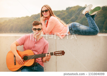 Happy couple with guitar outdoor Happy couple with guitar outdoor 131004099