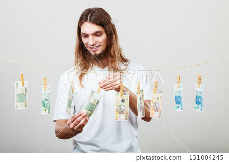Rich man with laundry of money 131004245