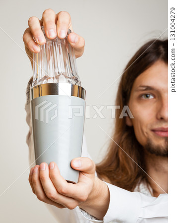 Young man with shaker making cocktail drink Young man with shaker making cocktail drink 131004279
