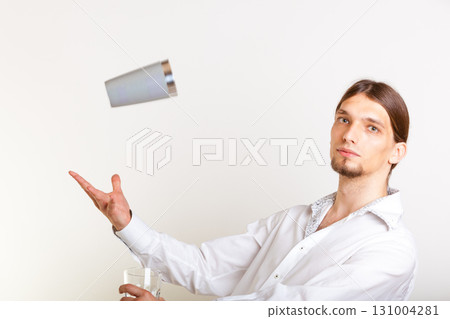 Skilled bartender juggling with glass. 131004281