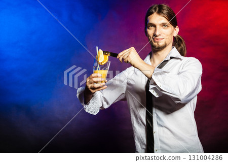 Bartender with orange drink. Bartender with orange drink. 131004286