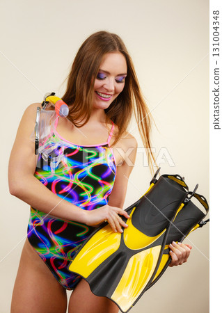Woman with flippers and snorkeling mask having fun 131004348