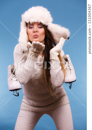 Woman with ice skates kiss gesture 131004367
