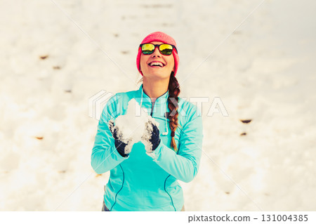 Young female holding snow 131004385