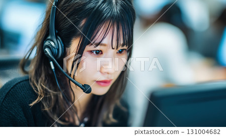 A female customer support operator working seriously 131004682