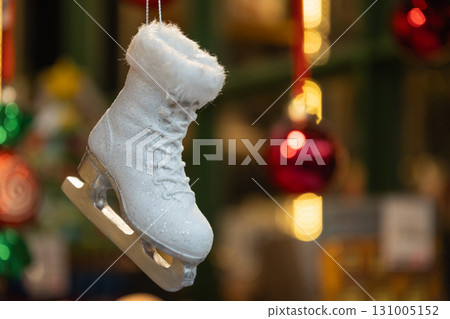 White racing skates toy for decoration Christmas Tree hanging for sale outdoors kiosk. Xmas holiday festivities and celebration. Close up. White racing skates toy for decoration Christmas Tree hanging for sale outdoors kiosk. Xmas holiday festivities and celebration. Close up. 131005152