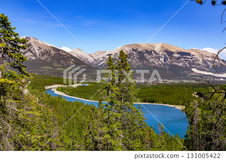 Scenic lake with clear blue waters among mountains and forests. Scenic lake with clear blue waters among mountains and forests. 131005422