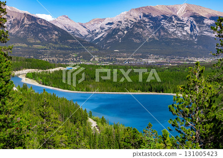 Scenic lake with clear blue waters among mountains and forests. Scenic lake with clear blue waters among mountains and forests. 131005423