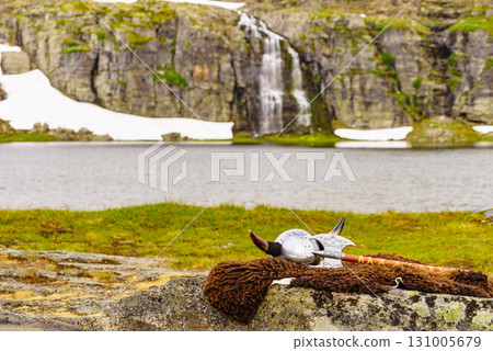 Viking helmet on lake shore, Norway Viking helmet on lake shore, Norway 131005679