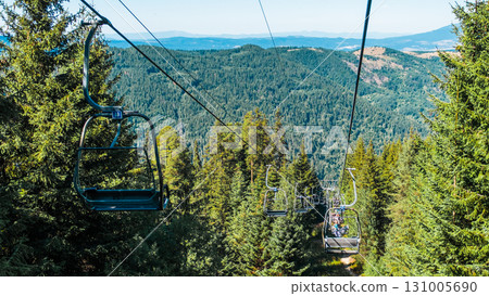 Chair Lift above the mountains and green forest of Bulgaria. Eco tourism. Tourist attraction. Seven Rila lakes. Cable car in the Rila Mountains 131005690
