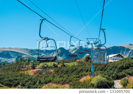 Chair Lift above the mountains and green forest of Bulgaria. Eco tourism. Tourist attraction. Seven Rila lakes. Cable car in the Rila Mountains Chair Lift above the mountains and green forest of Bulgaria. Eco tourism. Tourist attraction. Seven Rila lakes. Cable car in the Rila Mountains 131005700